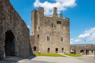 The castle on the right, with an entrance gate on the left