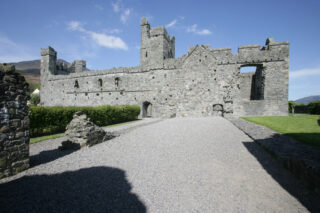 A view of the long side of Carlingford Abbey from the gravel walkway leading up to it